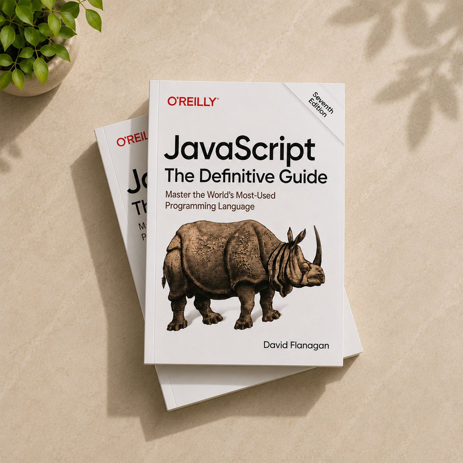 Two copies of JavaScript: The Definitive Guide by David Flanagan – O'Reilly Seventh Edition paperback stacked on a surface